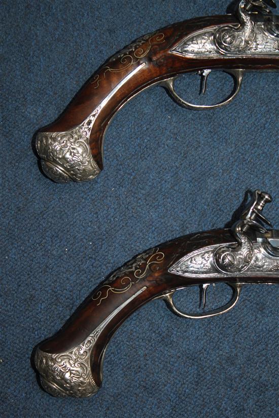 A pair of 18th century Bavarian flintlock holster pistols by Johann Jacob Kuchenreuter, overall length 21.5in.